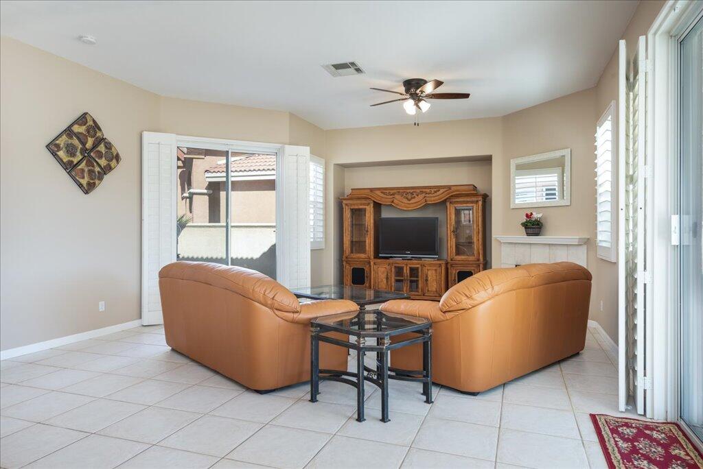 49562 Wayne Street Indio, CA 92201 - Photo 6 of 52 a living room with furniture and a fireplace