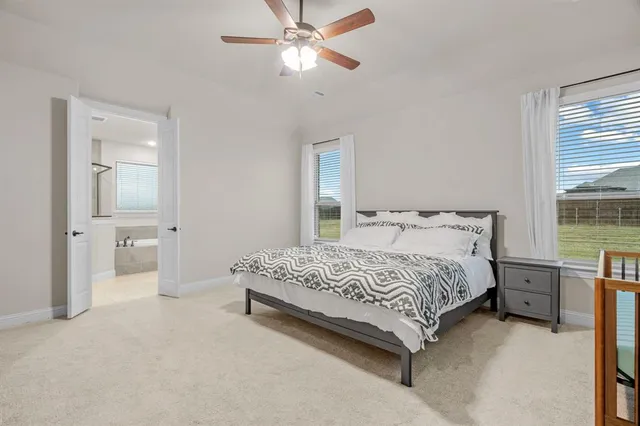 a bathroom with a tub a window and a shower