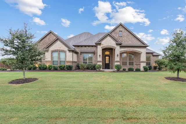 a view of a garden with a building in the background