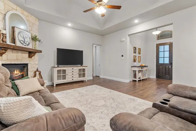 a living room with furniture a fireplace and a flat screen tv