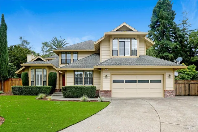 a front view of a house with a yard and garage