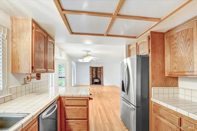 a kitchen with stainless steel appliances granite countertop a refrigerator and a sink