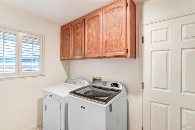 a kitchen with a sink cabinets and a window