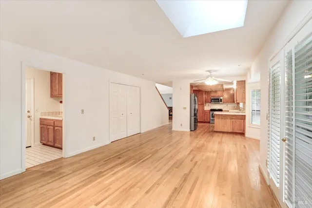 a view of a kitchen with a sink and a refrigerator