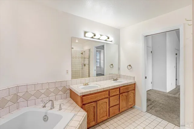 a spacious bathroom with a granite countertop sink and a mirror