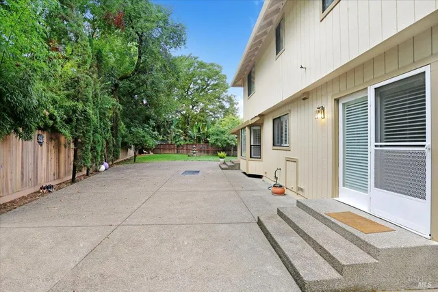 a view of a house with backyard and sitting area
