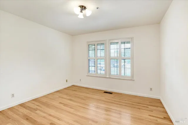 an empty room with a empty space and windows