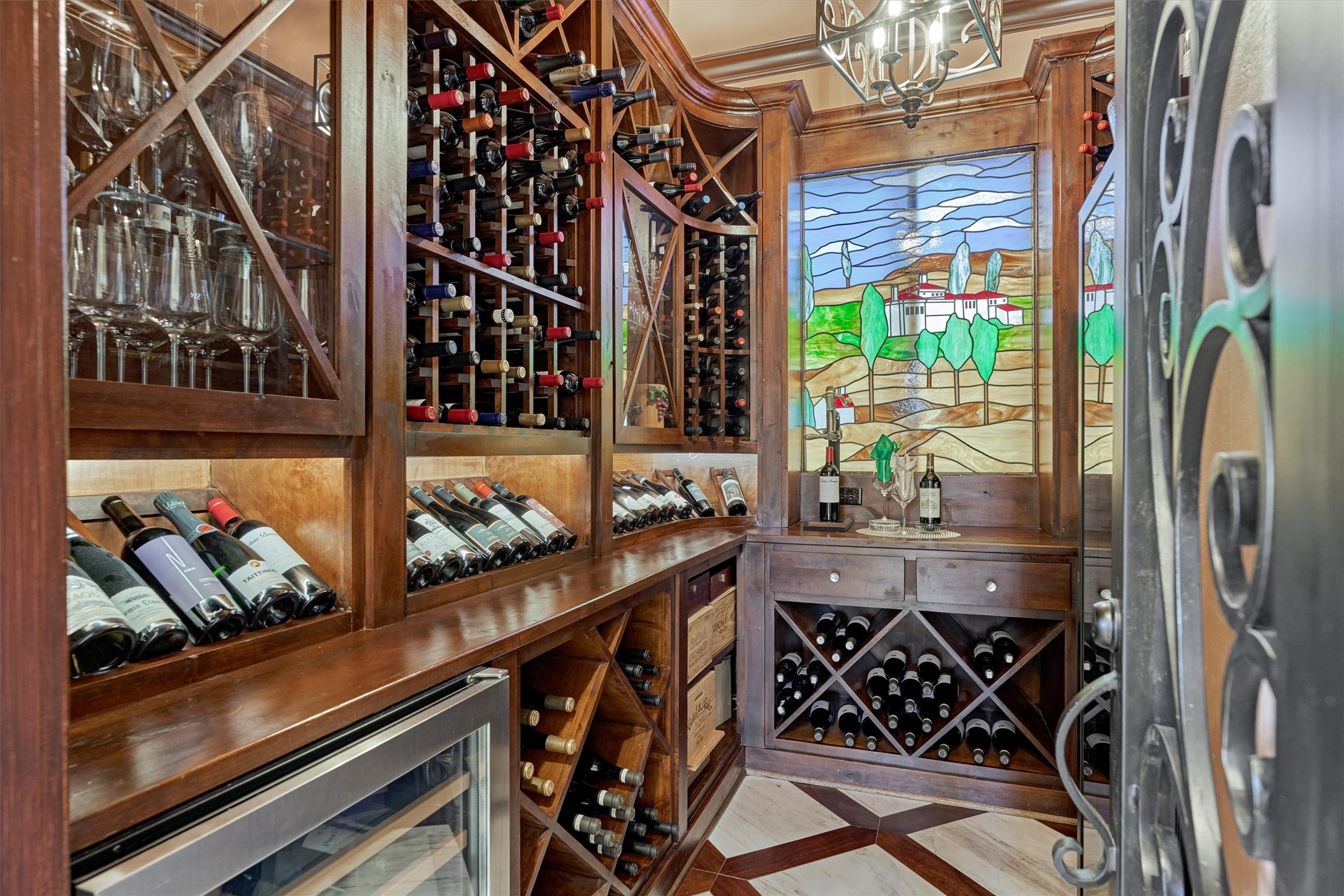 3 Dorset Square Spring, TX 77381 - Photo 15 of 50 Wine room with Whirlpool under-counter wine refrigerator. Stained glass is the back of the home set in Tuscan-style landscape.