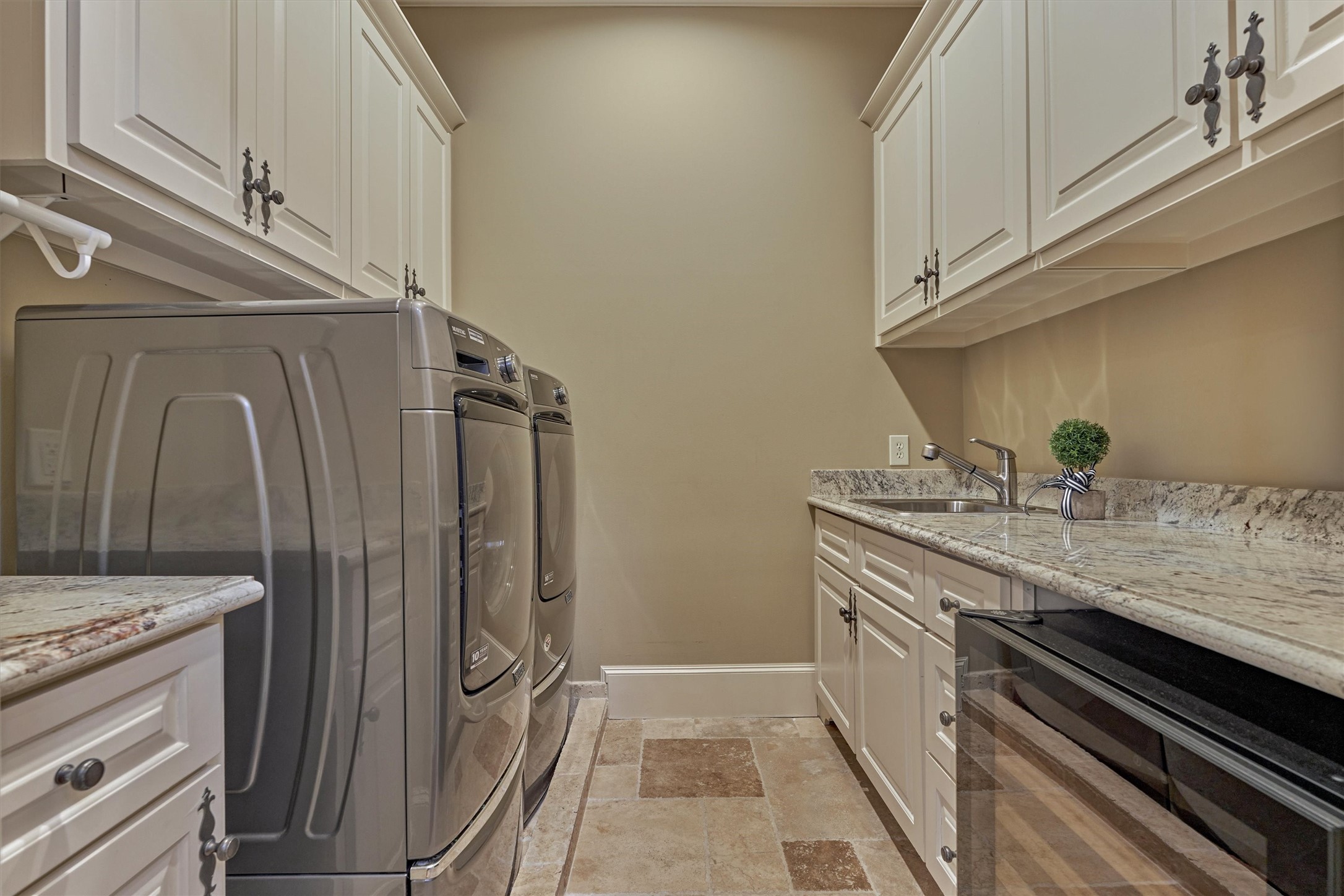 3 Dorset Square Spring, TX 77381 - Photo 37 of 50 Laundry on second floor. Granite counter, sink, folding space, Maytag washer and dryer (convey), and EuroCave wine refrigerator (conveys).
