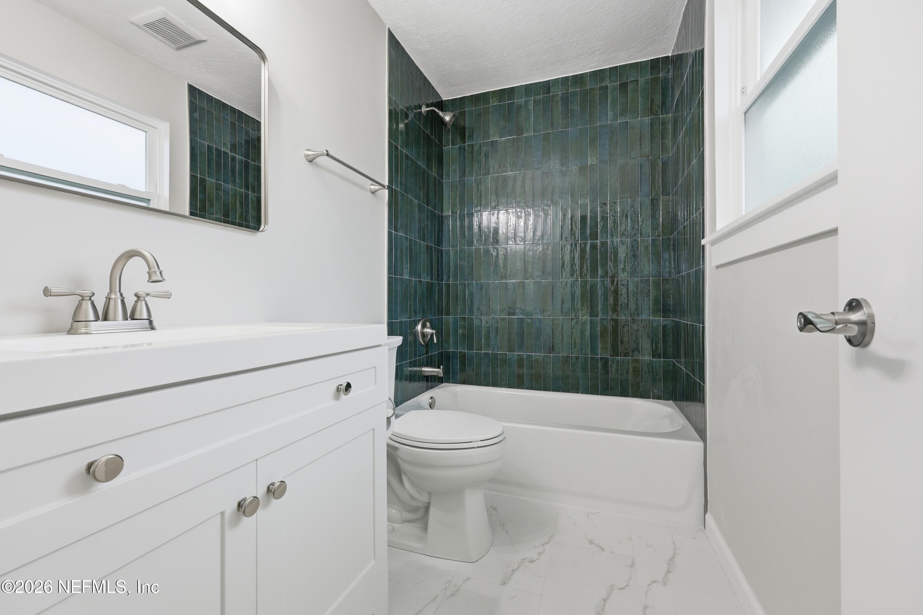 7 Cobia Street Ponte Vedra Beach, FL 32082 - Photo 12 of 20 a bathroom with a shower a sink a toilet and mirror
