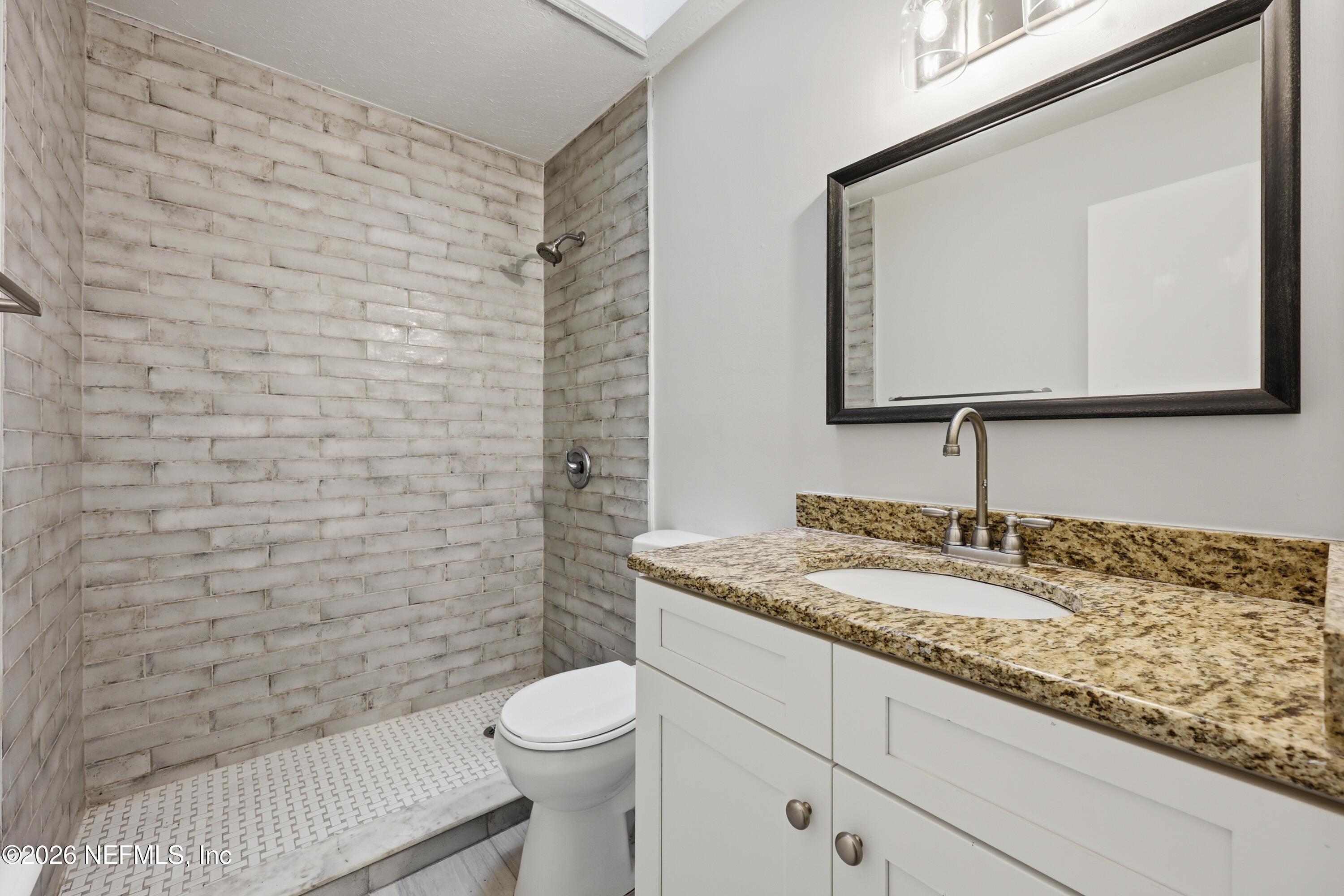 7 Cobia Street Ponte Vedra Beach, FL 32082 - Photo 15 of 20 a bathroom with a granite countertop toilet sink and mirror