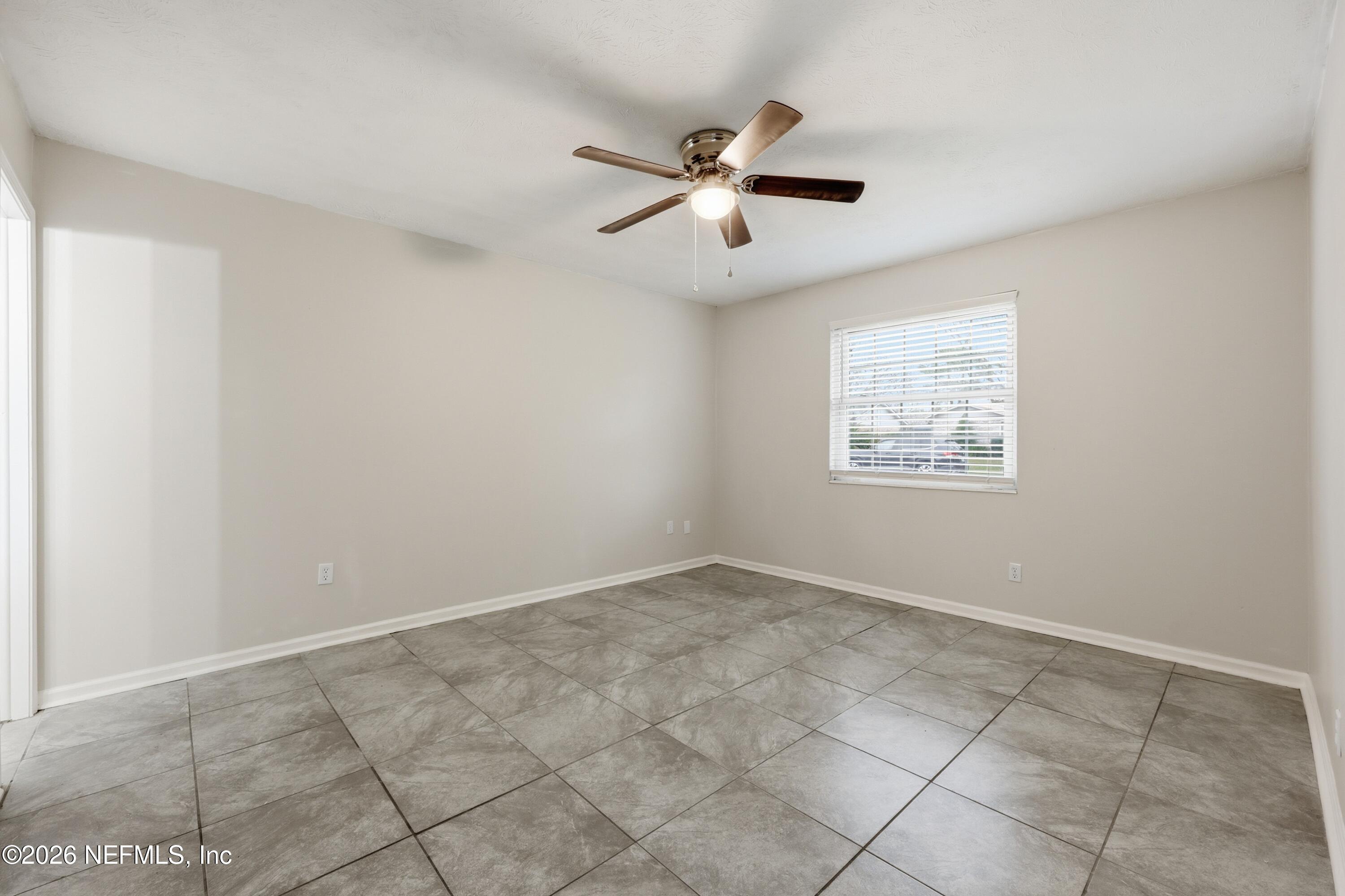 7 Cobia Street Ponte Vedra Beach, FL 32082 - Photo 10 of 20 an empty room with windows and fan
