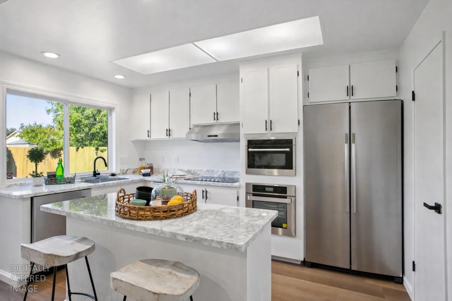 32402 Rutherford Lane Union City, CA 94587 - Photo 20 of 55 a kitchen with a refrigerator a stove a sink and a dining table with chairs