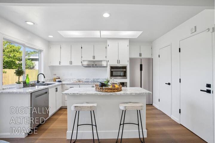 32402 Rutherford Lane Union City, CA 94587 - Photo 22 of 55 a kitchen with stainless steel appliances kitchen island granite countertop a dining table chairs and white cabinets