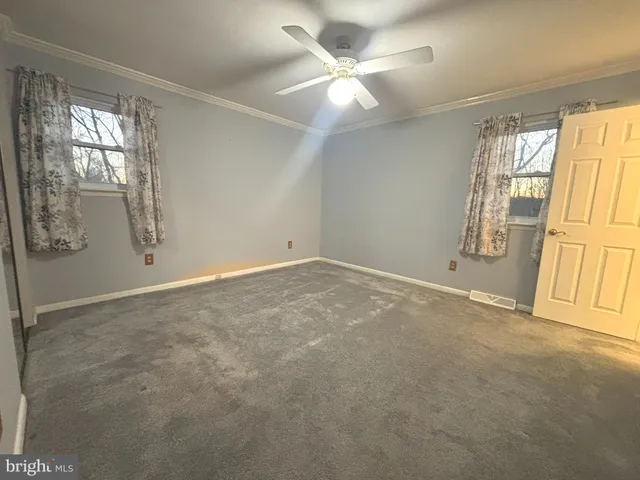 a white toilet sitting next to a white sink and vanity