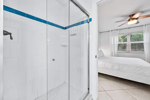 a living room with furniture a fireplace and a chandelier