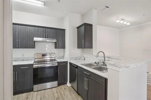 a kitchen with a refrigerator and a sink