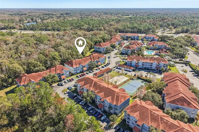 an aerial view of house with yard and ocean view