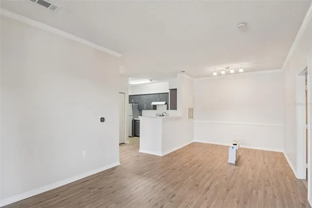 a view of a kitchen with wooden floor and a sink