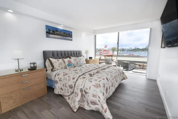 a bedroom with a large bed and a large window