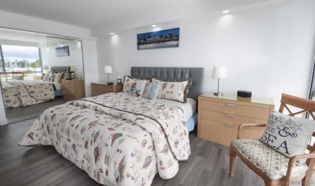 a bedroom with a bed and a mirror