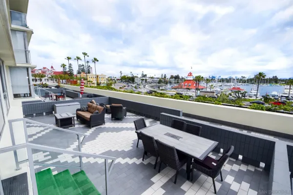 a terrace with outdoor seating and city view