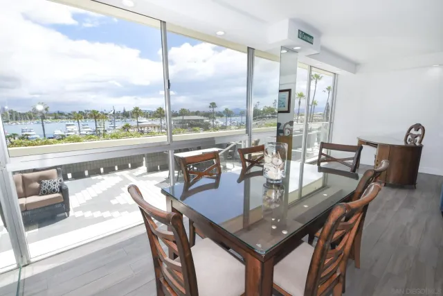 a dining room with furniture a chandelier and wooden floor