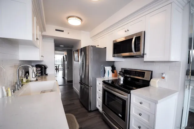 a kitchen with stainless steel appliances a stove microwave and a refrigerator