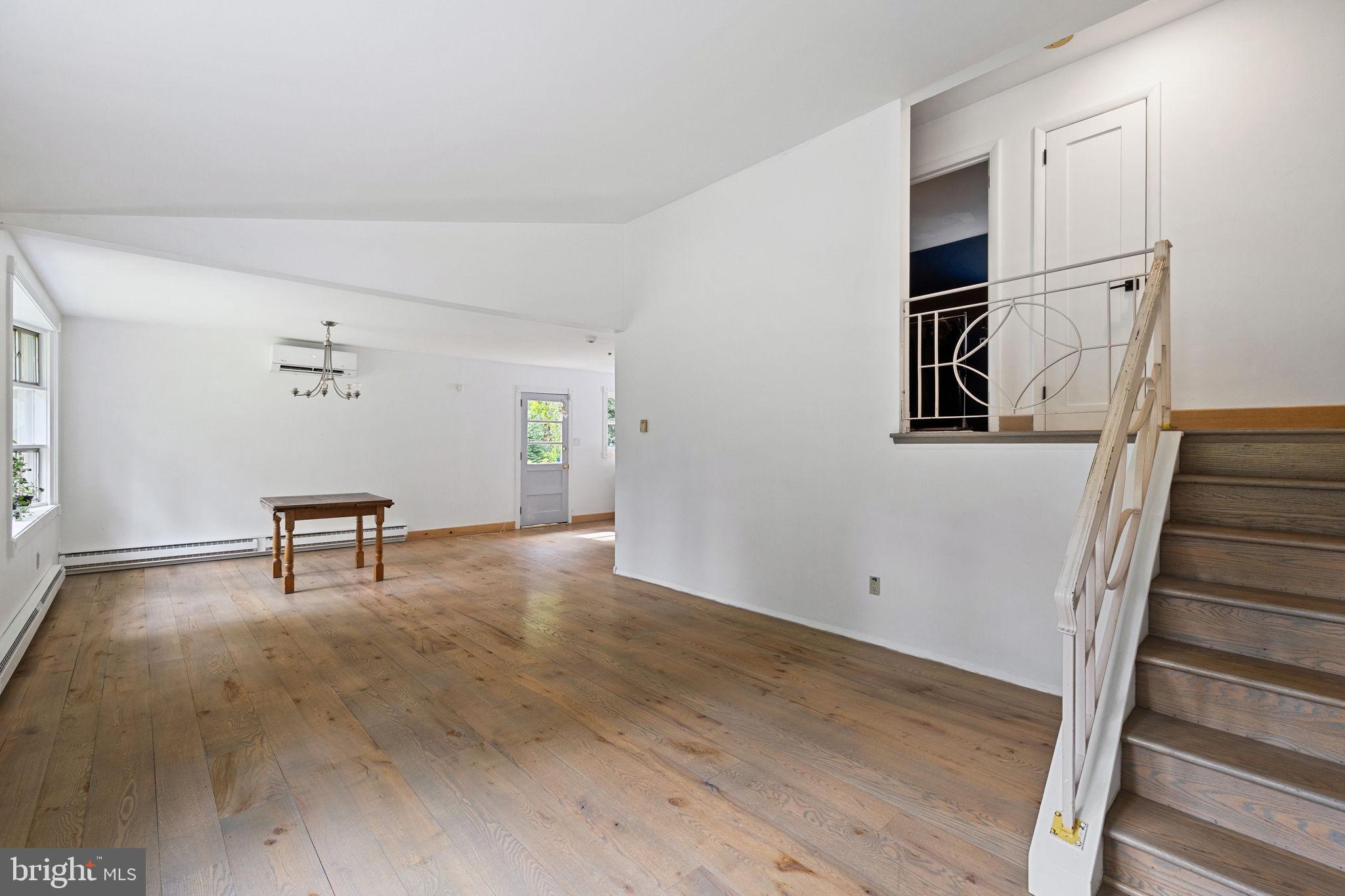 601 Cathcart Road Blue Bell, PA 19422 - Photo 8 of 38 a view of a livingroom with wooden floor and stairs