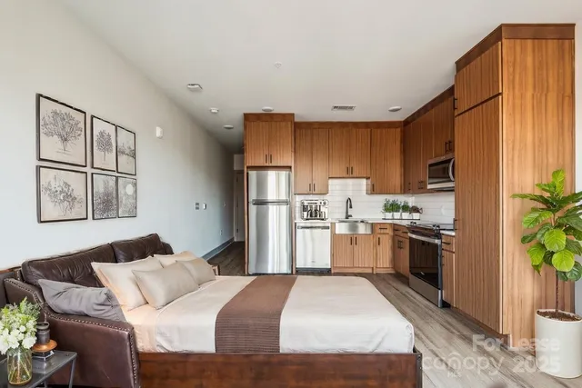 a kitchen with a refrigerator a stove top oven a sink and cabinets