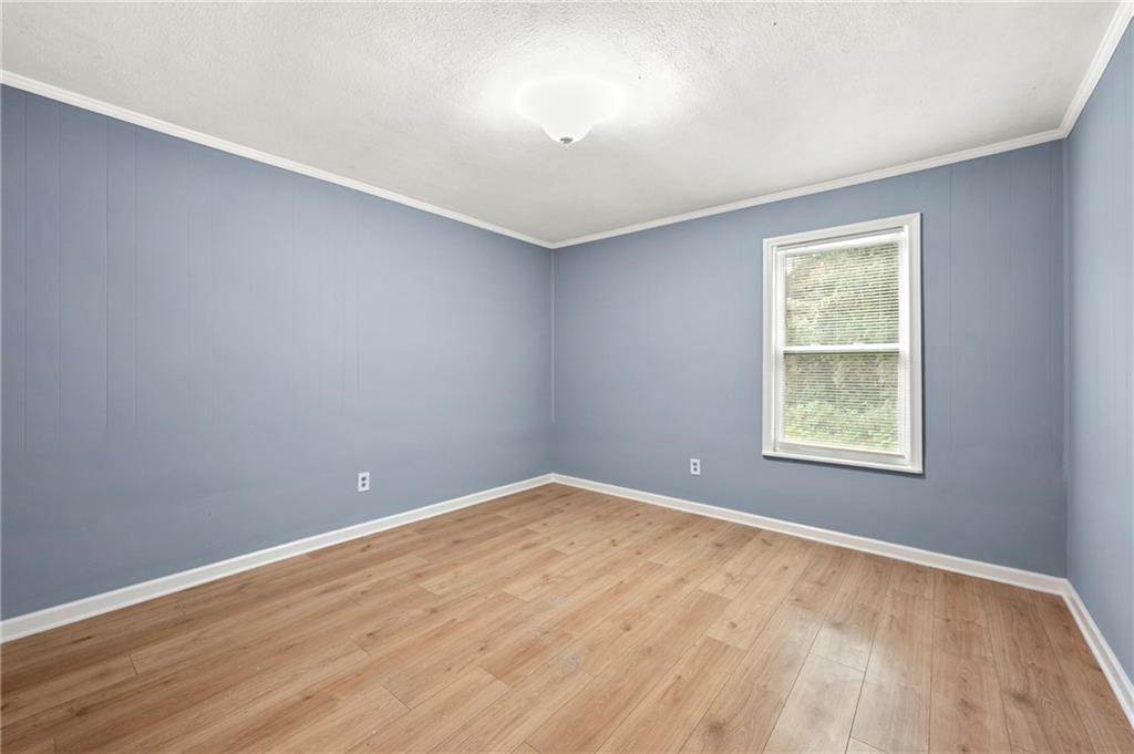 6708 Baynes Hill Circle Clarkston, GA 30021 - Photo 15 of 17 wooden floor in an empty room with a window