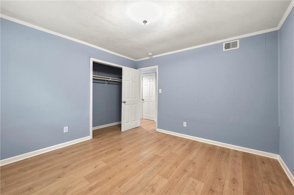 6708 Baynes Hill Circle Clarkston, GA 30021 - Photo 17 of 17 a view of an empty room with wooden floor