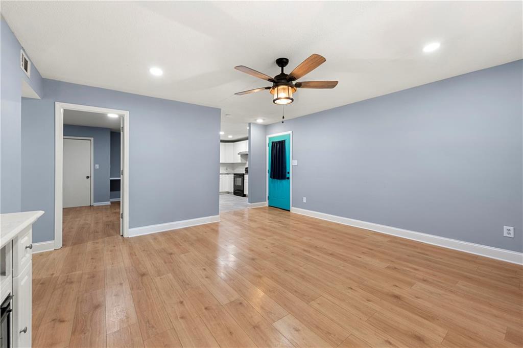 6708 Baynes Hill Circle Clarkston, GA 30021 - Photo 4 of 17 a view of a big room with wooden floor and a ceiling fan