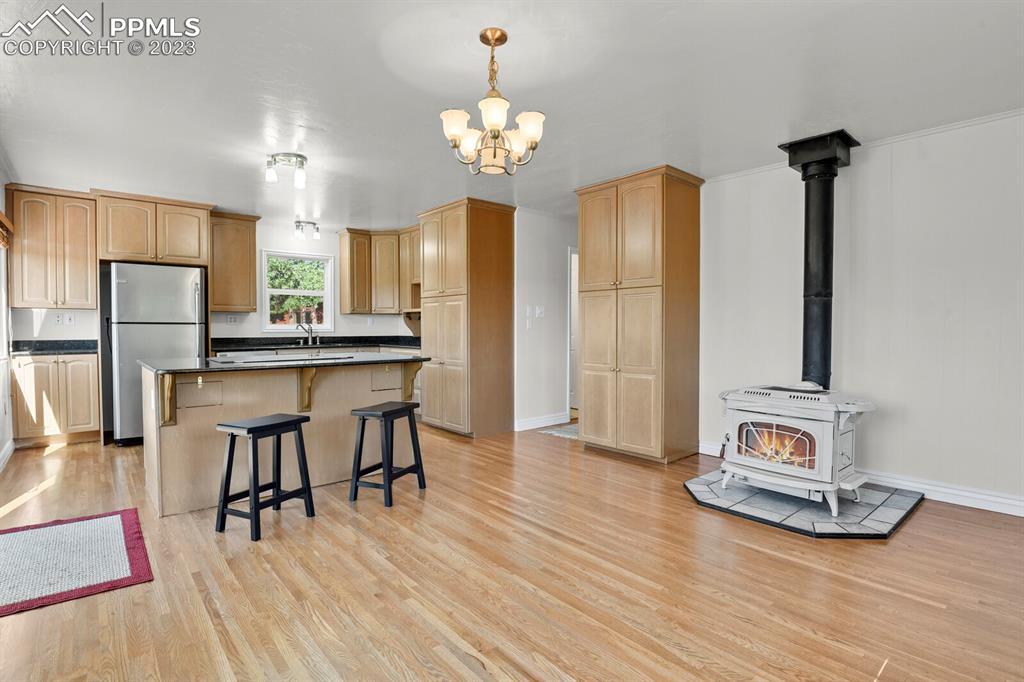 286 Ridge Road Divide, CO 80814 - Photo 12 of 27 a view of a dining room with furniture a chandelier and wooden floor