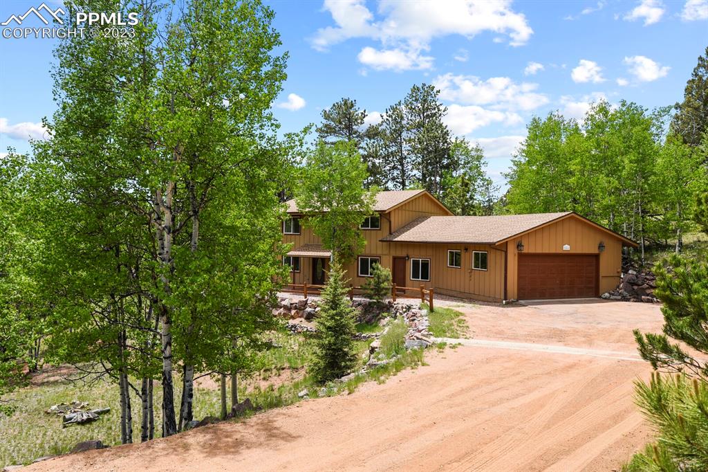 286 Ridge Road Divide, CO 80814 - Photo 4 of 27 a front view of a house with a yard