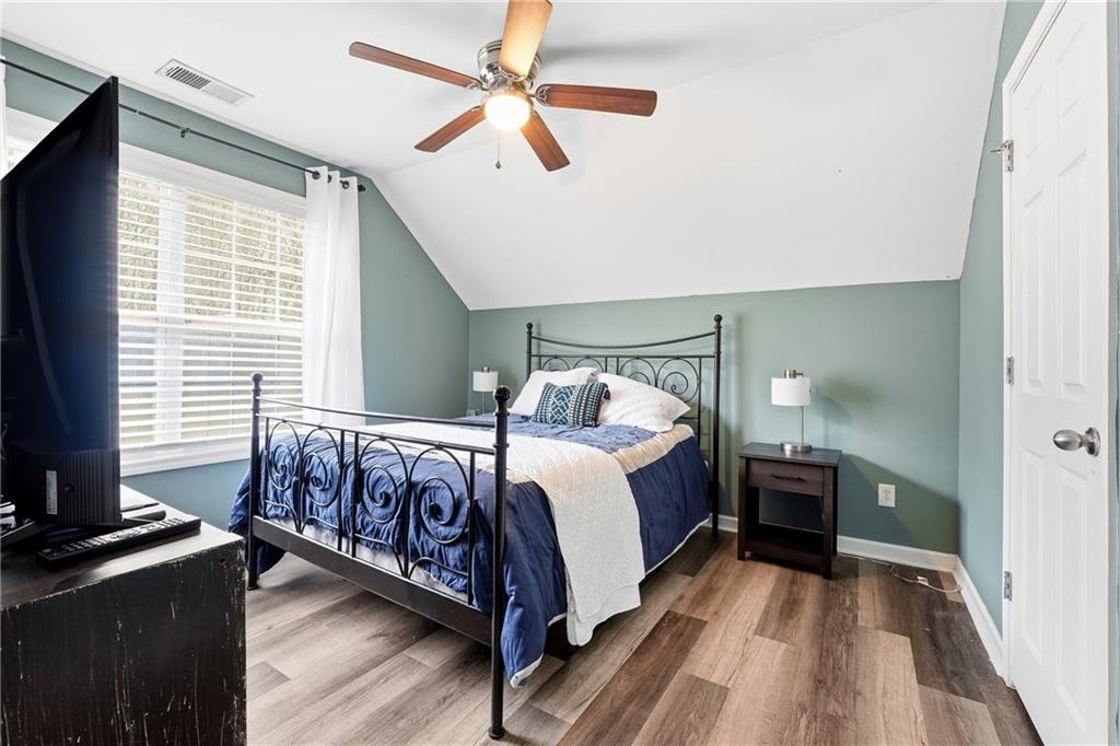 14 Isabella Court Cartersville, GA 30121 - Photo 23 of 33 a bedroom with a bed and a chandelier