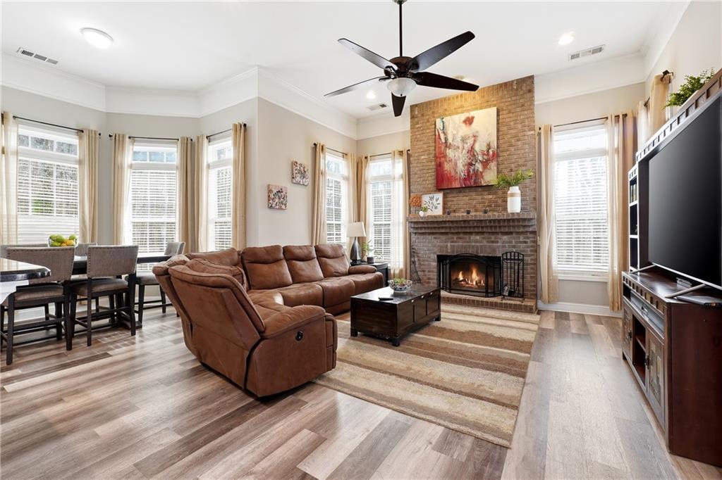 14 Isabella Court Cartersville, GA 30121 - Photo 8 of 33 a living room with furniture a flat screen tv and a fireplace