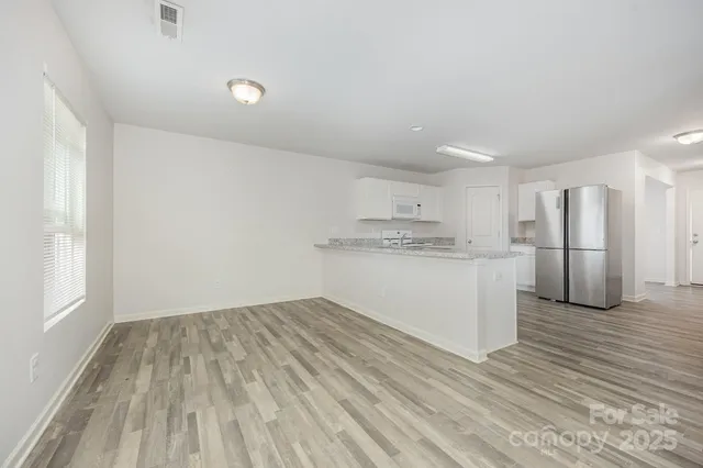 a view of kitchen with wooden floor