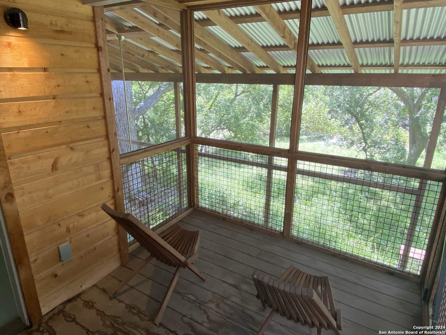 412 Lebouf Road Utopia, TX 78884 - Photo 11 of 42 a view of a room with wooden floor and windows