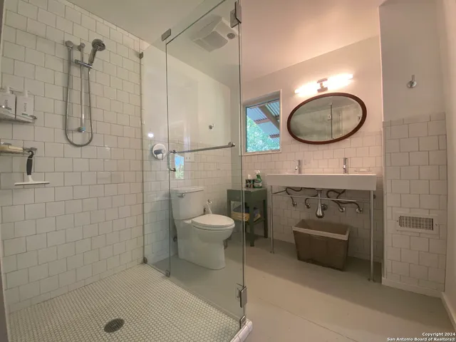 a balcony with wooden floor and outdoor seating