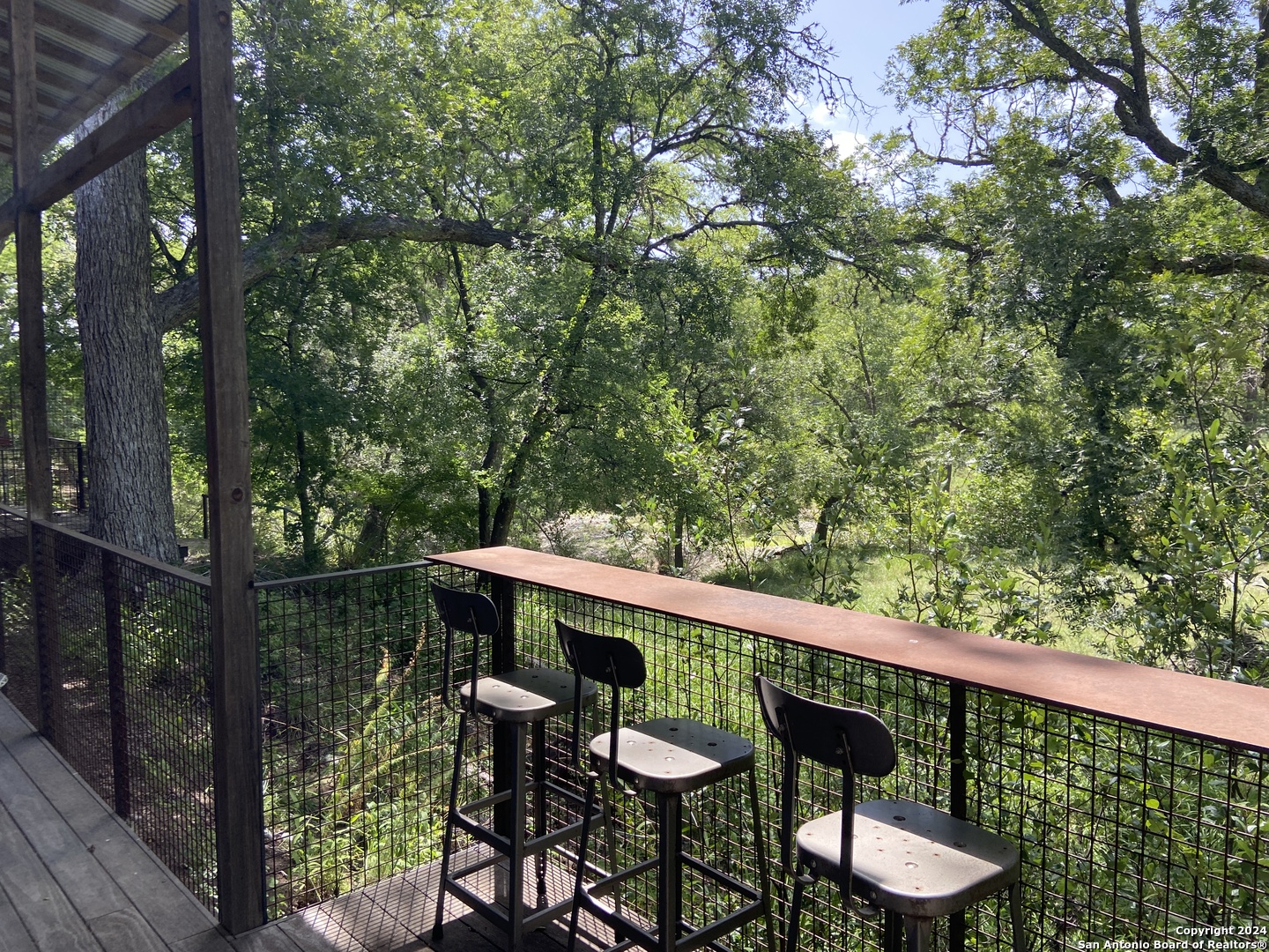 412 Lebouf Road Utopia, TX 78884 - Photo 15 of 42 a balcony with wooden floor and outdoor seating