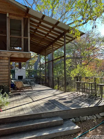a view of backyard with seating area and trees