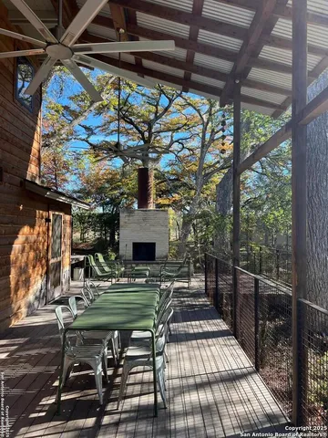 a backyard of a house with a yard with plants and large trees