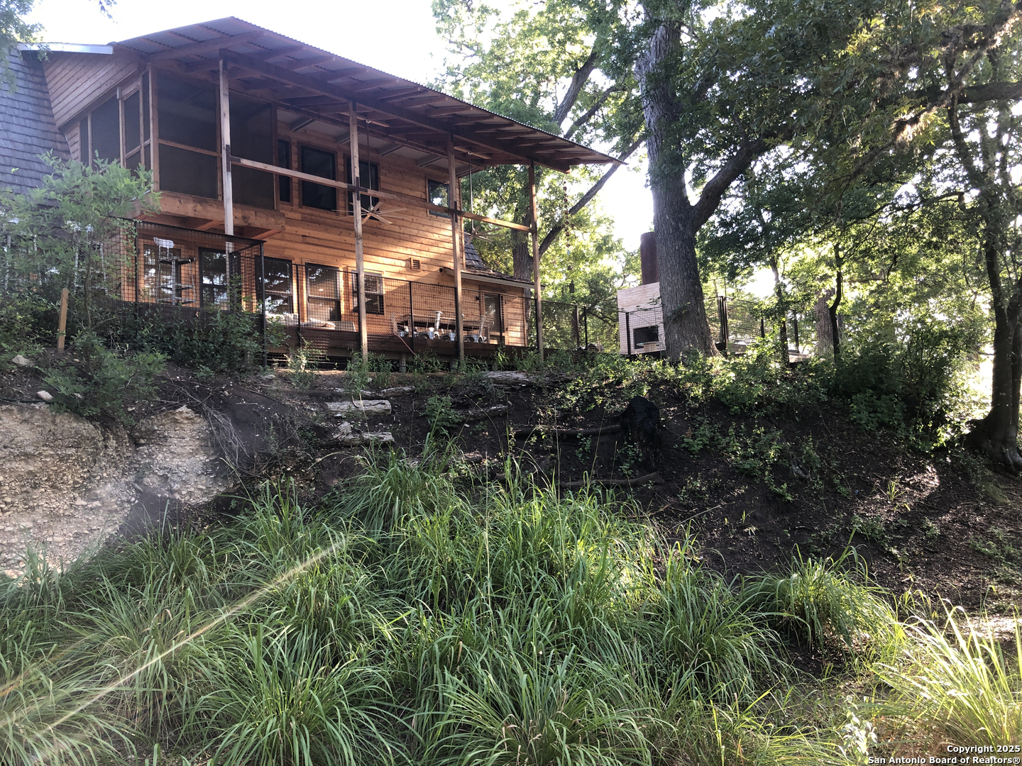 412 Lebouf Road Utopia, TX 78884 - Photo 6 of 42 a backyard of a house with lots of green space