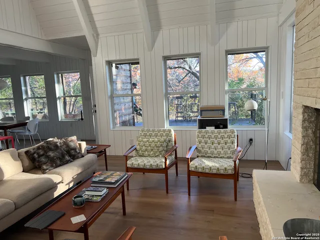 a view of a room with wooden floor and windows