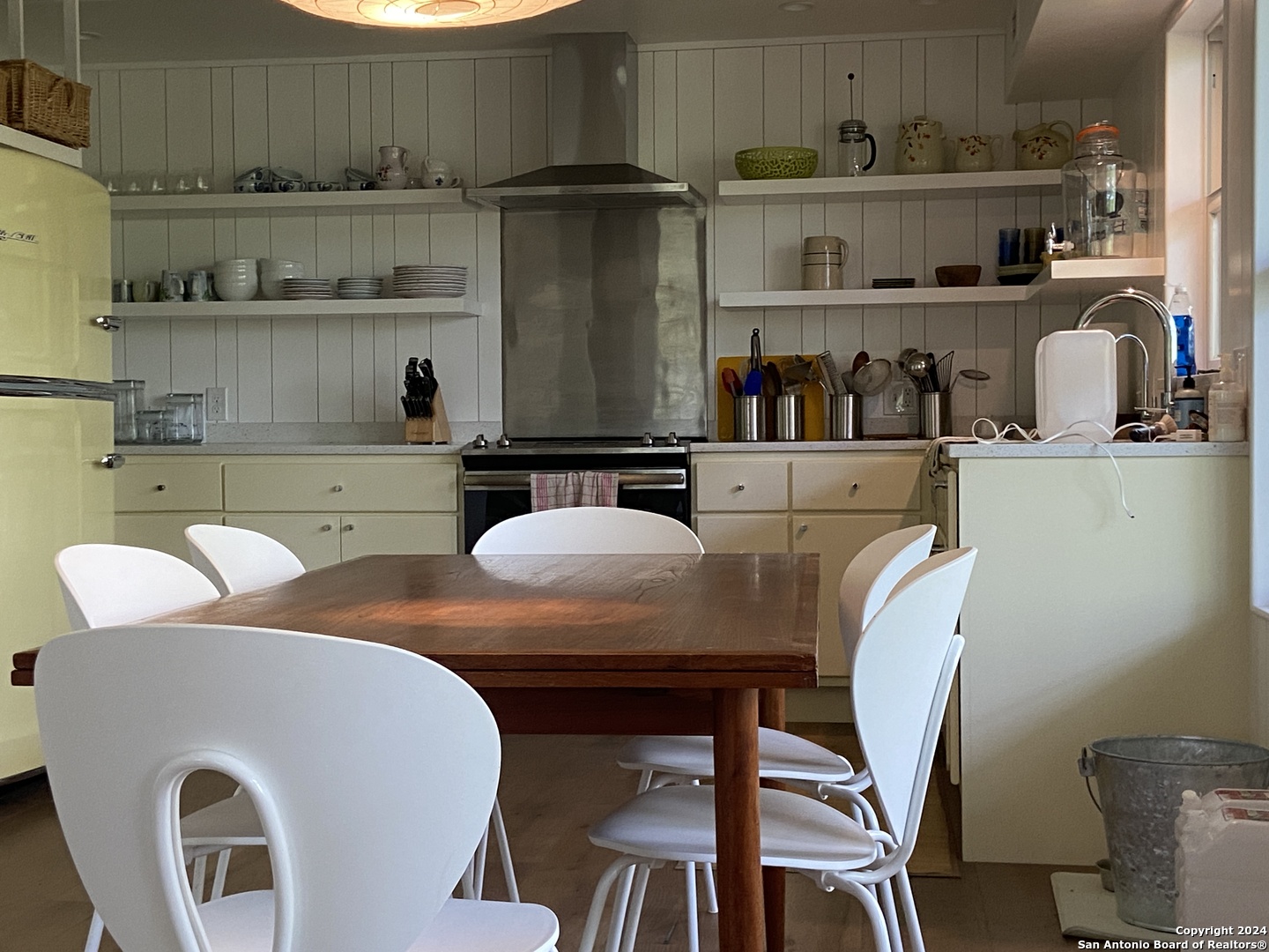 412 Lebouf Road Utopia, TX 78884 - Photo 10 of 42 a kitchen with a dining table chairs and a refrigerator