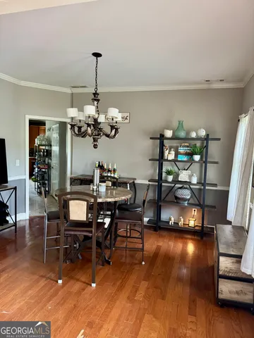 a view of a dining room with furniture and chandelier