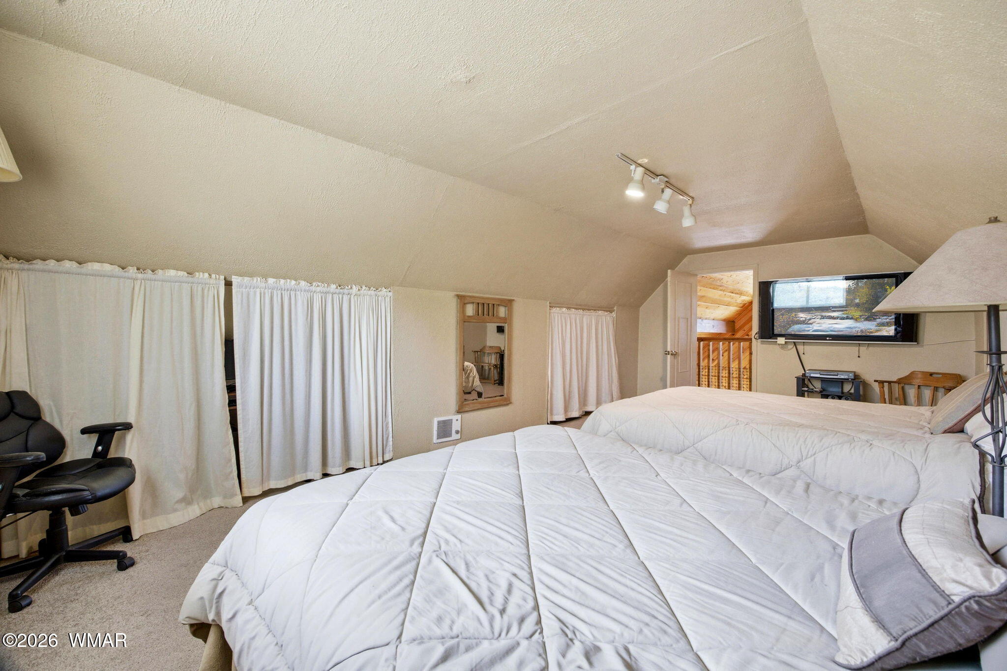 3072 Chevelon Road Overgaard, AZ 85933 - Photo 19 of 43 a bedroom with a large bed and a window