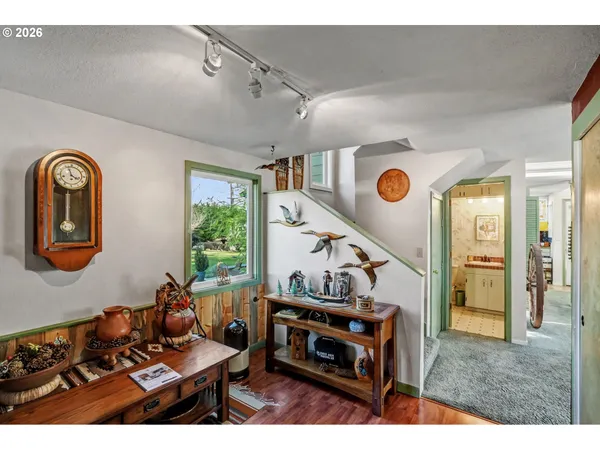 a living room with furniture a fireplace and a large window