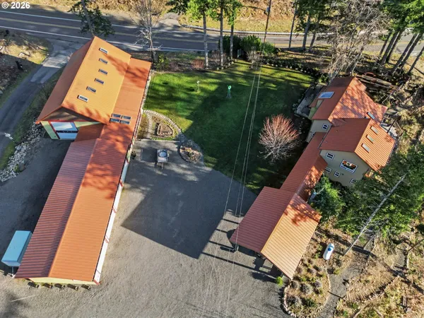 an aerial view of a house with a yard basket ball court and a fountain